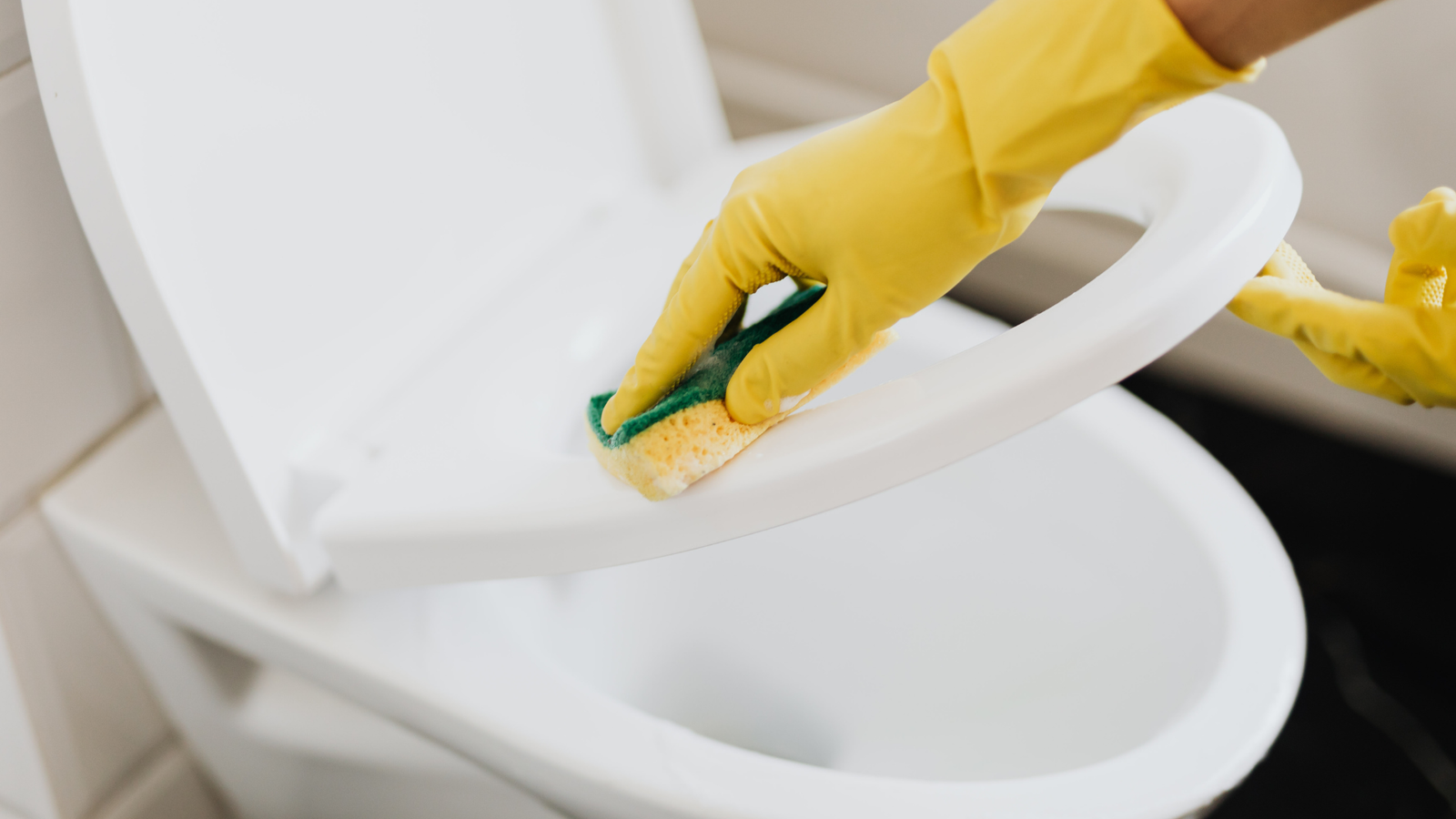 Toilet being cleaned during a deep cleaning service by Lux Professional Cleaning